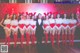 a group of women in red and white outfits posing for a photo