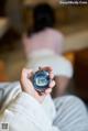 A person holding a digital watch in their hand.