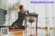 A woman sitting on the floor next to a table.