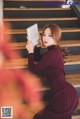 A woman sitting on the stairs reading a book.