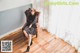 A woman sitting on a chair in a room.