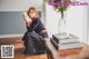 a woman sitting on the floor reading a book