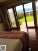 A bedroom with a view of the ocean and mountains.