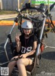 A woman sitting in a chair with a helmet on.