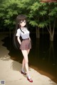 A girl in a school uniform standing in front of a pond.