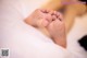 A close up of a baby's feet on a bed.