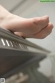 A close up of a person's foot on a piano.