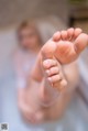 A close up of a baby's feet in a bathtub.