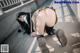 A woman in a school uniform is bending over on the ground.