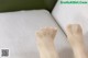 A close up of a person's feet on a bed.