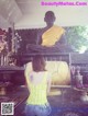 A woman sitting in front of a statue of a buddha.