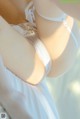 A close up of a woman wearing a white lingerie.