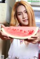 A woman holding a slice of watermelon in her hands.