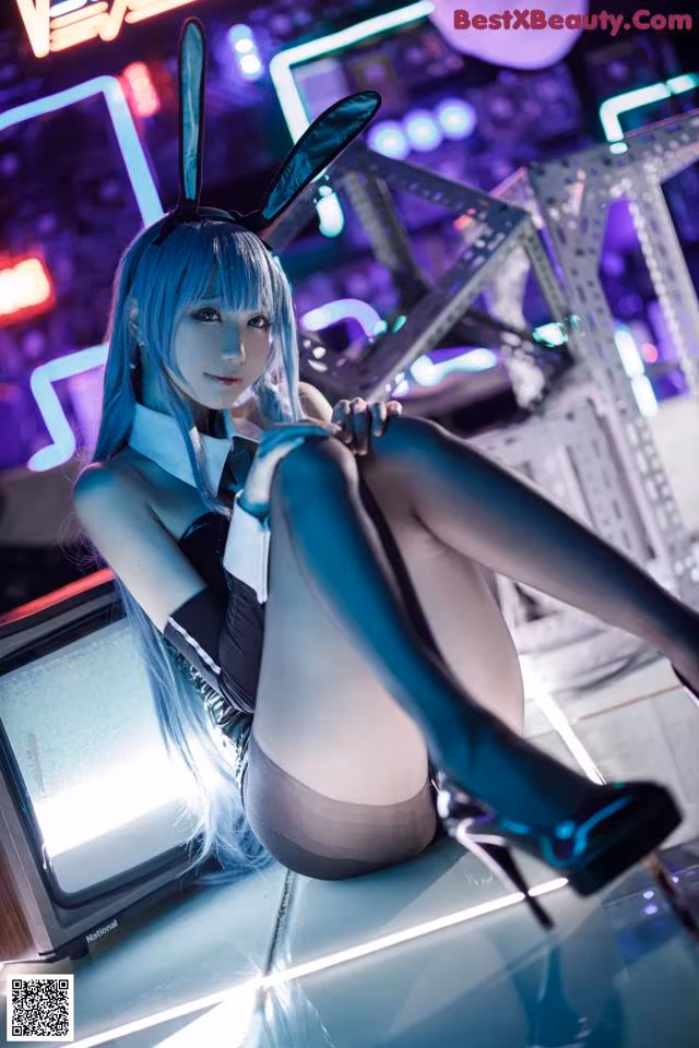 A woman in bunny ears sitting on top of a table.