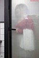 A person standing in front of a glass door.